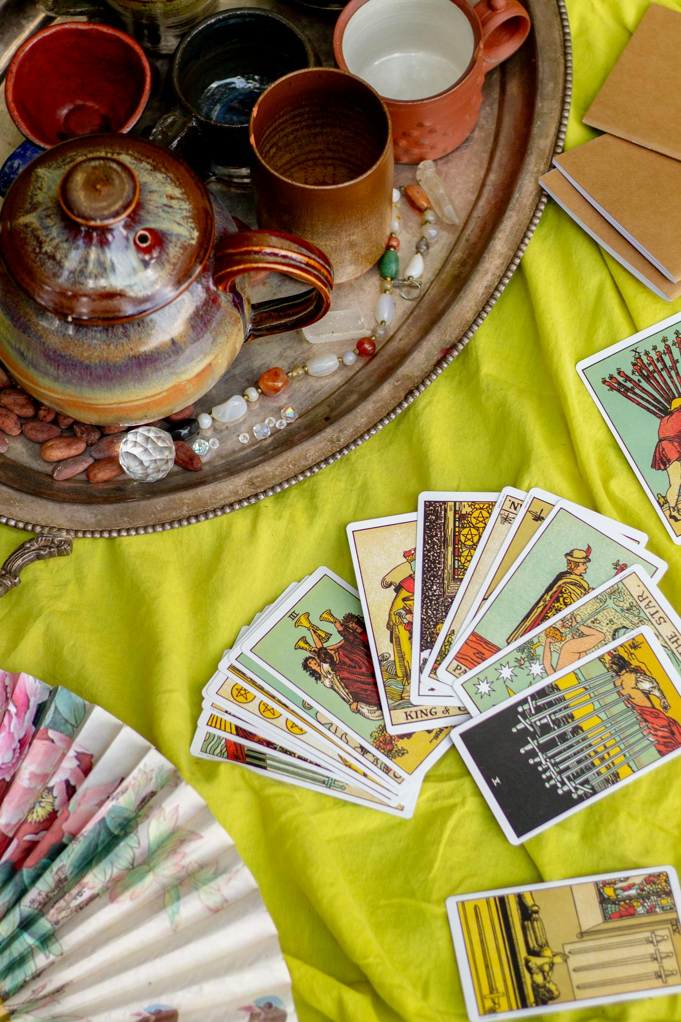 Vibrant setup for a tarot reading session with tea and spiritual items.